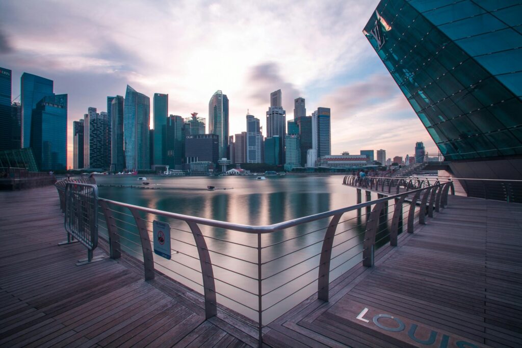 pexels-photo-302831-302831 Breathtaking view of Singapore's modern skyline reflecting on the water at twilight.